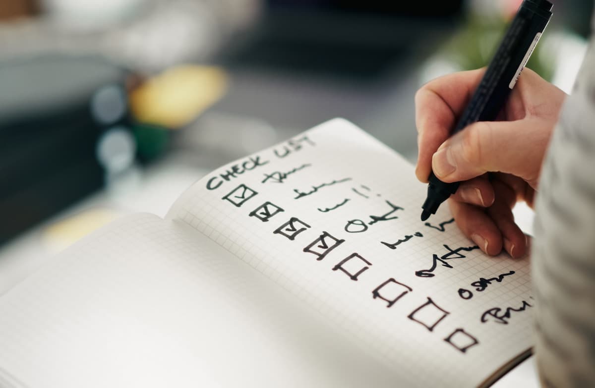 Hand marking items off a quality checklist, llms.txt file audit results